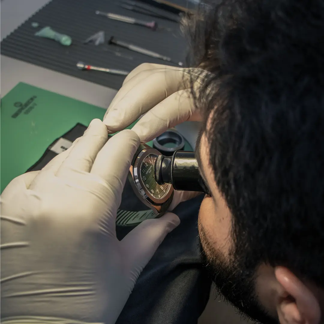 Image showing one of TP Labs technicians inspecting Patek Philippe watch